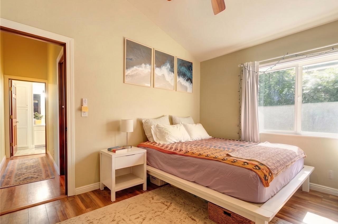 Main House bedroom with large window and bathroom doorway