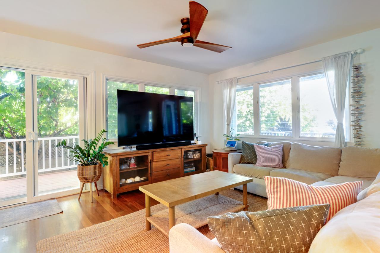 Main House living room with large windows and TV