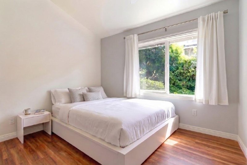 Main House bright bedroom with garden-view window